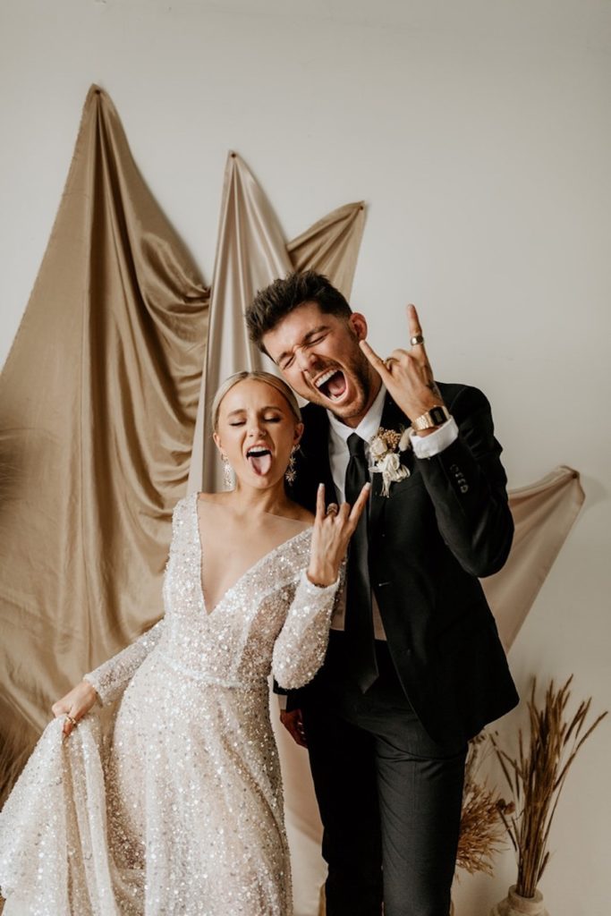 Bride and groom posing like rockstars during their wedding photoshoot