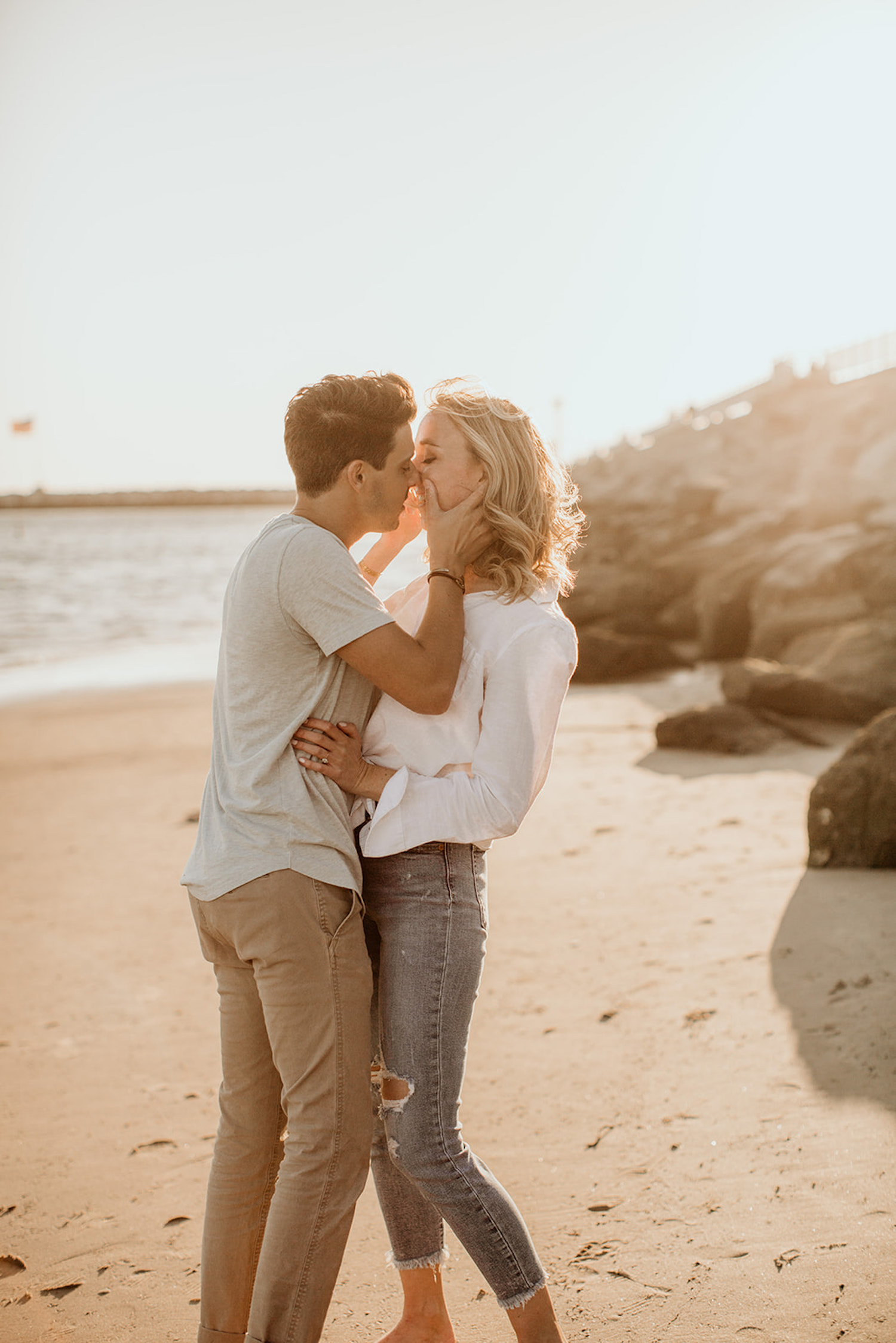 A couple kisses on the shores of Venice Beach during their engagement session with Morgan Wirth photography