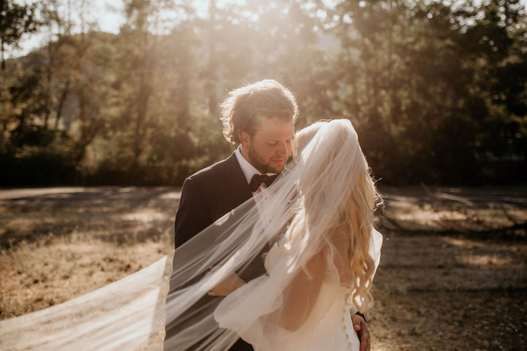 Bride and groom pose at golden hour during their Oregon Elopement