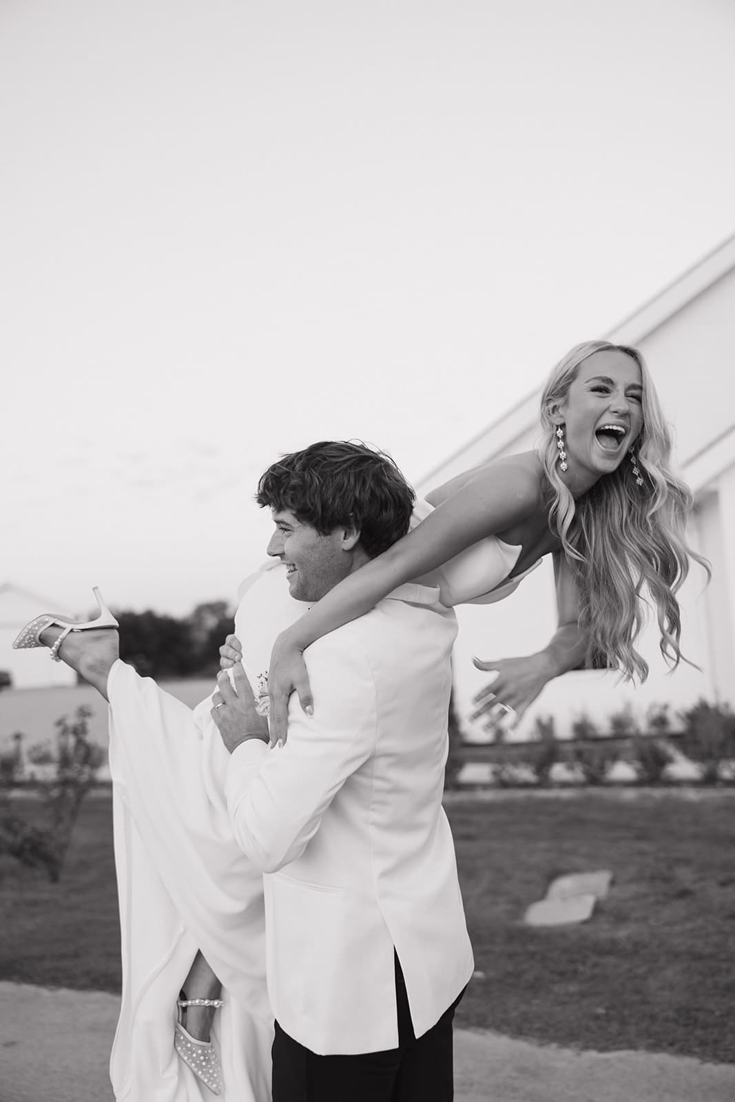 groom carrying bride over his shoulder