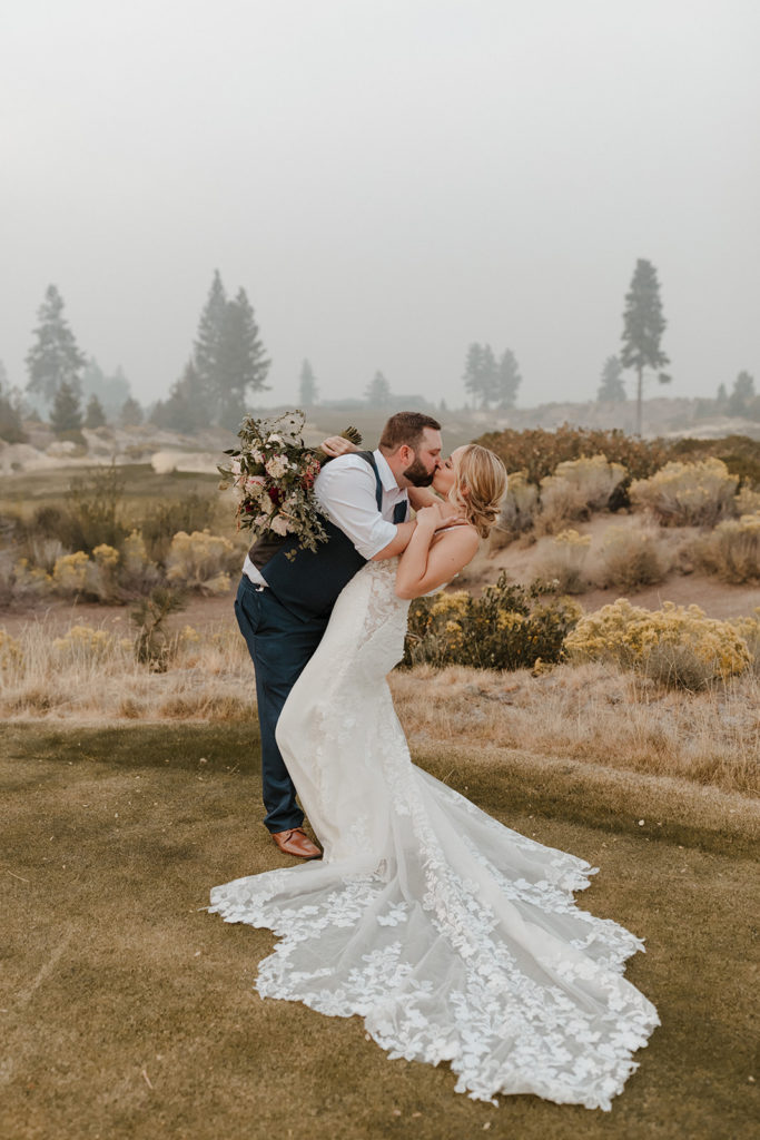 Groom leans in and kisses the bride during their wedding shoot at Tetherow Resort in Bend, OR