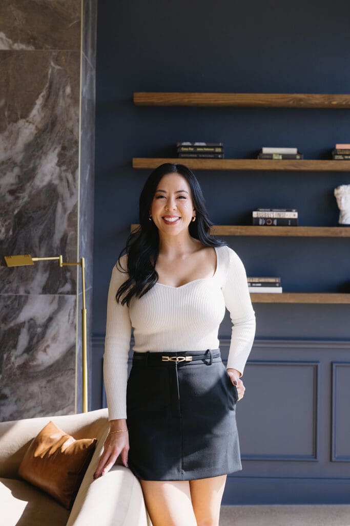 Lifestyle branding photo of woman walking through luxury Dallas med spa interior.