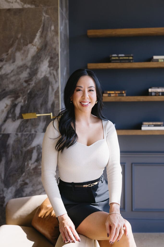 Lifestyle branding photo of woman walking through luxury Dallas med spa interior.
