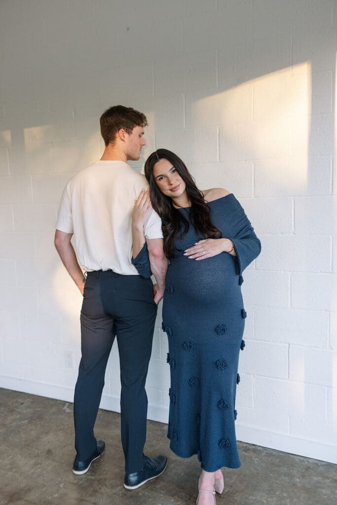 Editorial maternity portraits with warm light and natural posing at a Dallas studio.