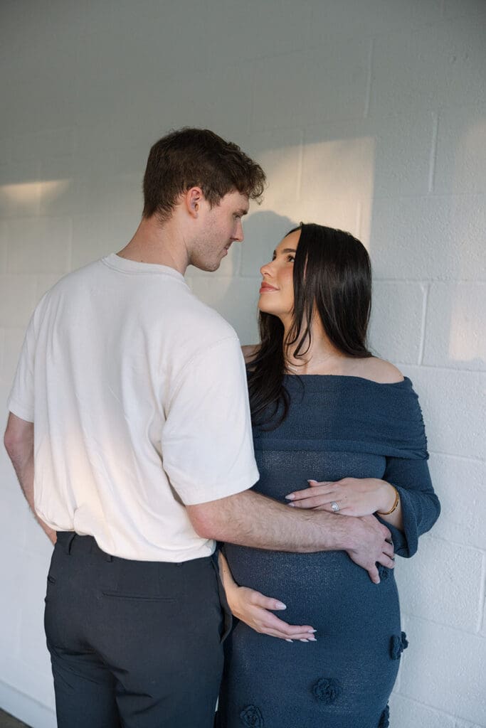 Editorial maternity portraits with warm light and natural posing at a Dallas studio.
