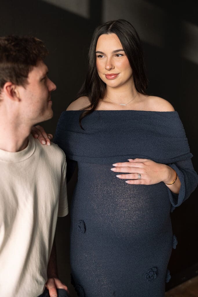 Maternity photoshoot with timeless editorial style and soft window lighting in Dallas.