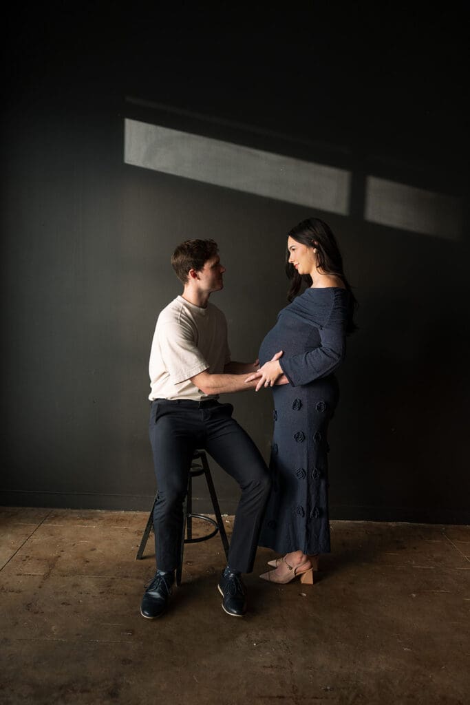 Maternity photoshoot with timeless editorial style and soft window lighting in Dallas.
