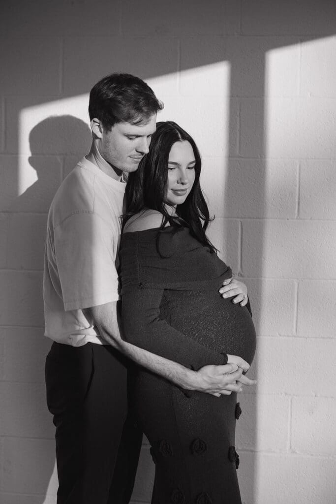 Expecting parents sharing a quiet, intimate moment during their maternity photoshoot in Dallas.