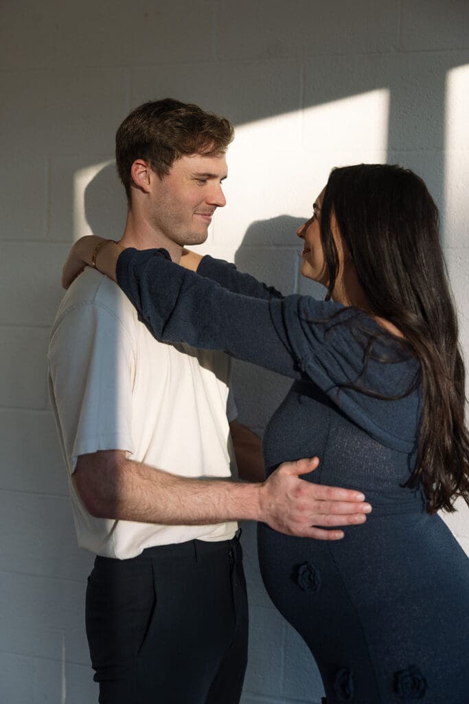 Expecting parents sharing a quiet, intimate moment during their maternity photoshoot in Dallas.
