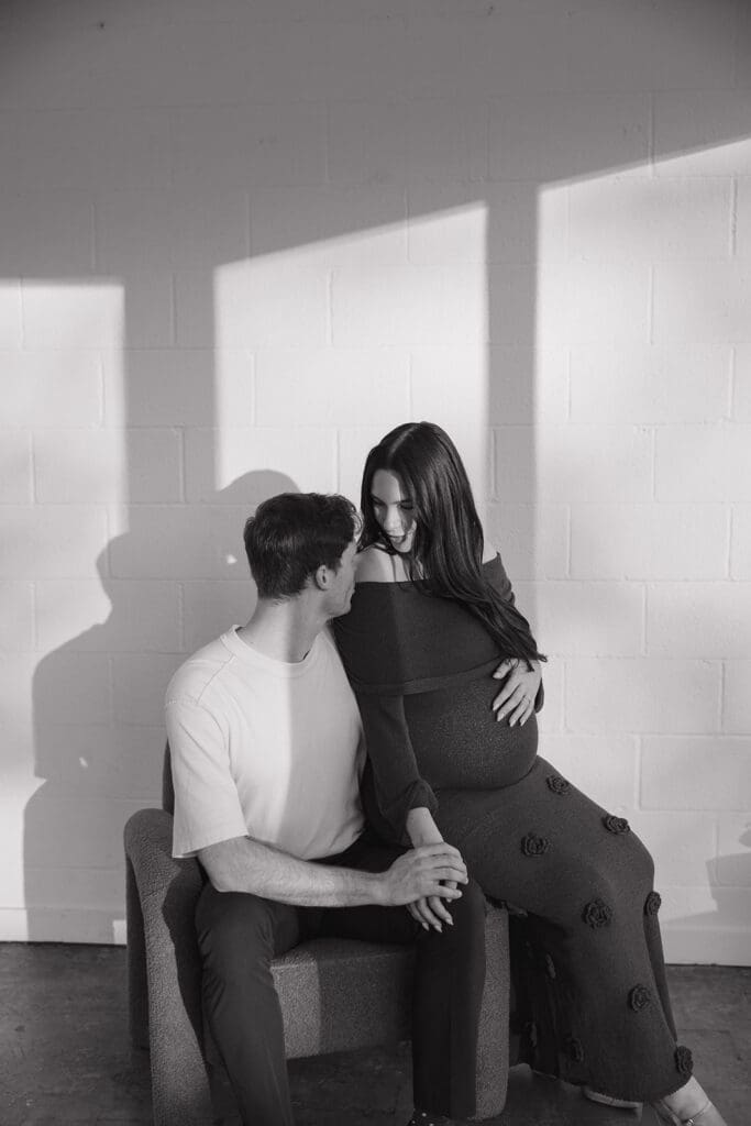 Expecting parents sharing a quiet, intimate moment during their maternity photoshoot in Dallas.