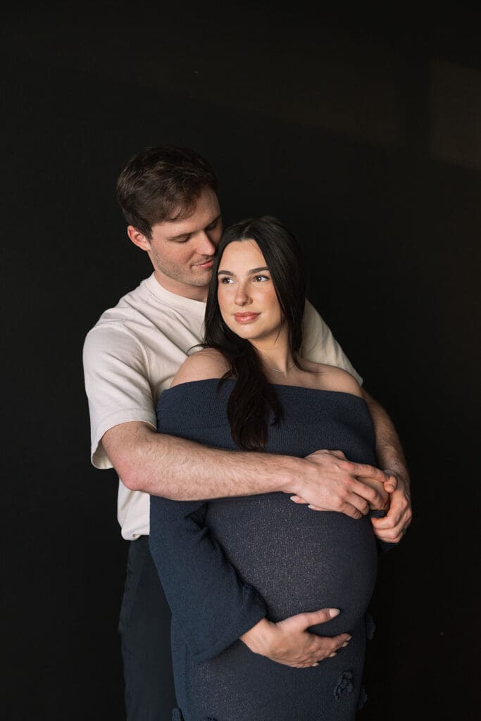 Editorial maternity portraits with warm light and natural posing at a Dallas studio.
