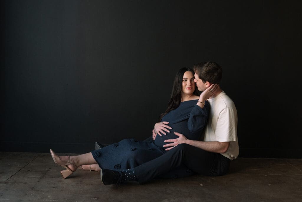 Editorial maternity portraits with warm light and natural posing at a Dallas studio.