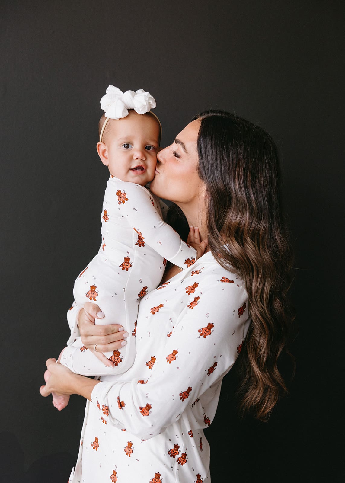 Kids wearing matching Halloween pajamas from Shop Talulah during cozy brand photoshoot